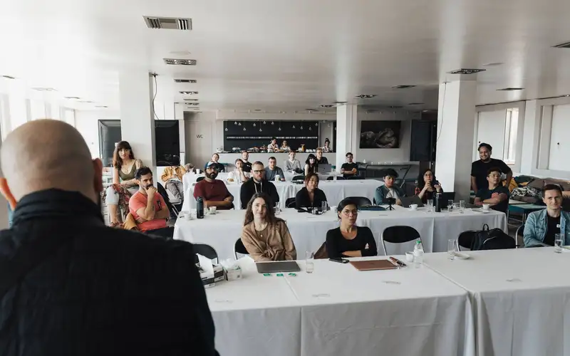 A full room of professionals during an assessment